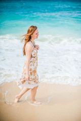 The girl walks on the water's edge on the Boracay