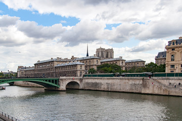 PARIS, FRANCE CIRCA APR 2016. Partial view of Notre Dame bridge, To the right the conciergerie and towers of the cathedral of Notre Dame de Paris. View from the river Seine