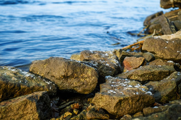 Fototapeta na wymiar Stones lying on the bank of river
