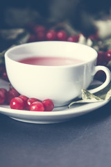 tea with viburnum berries in a cup on the table