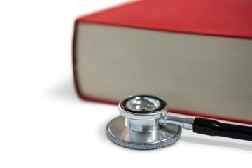 Stethoscope with book on white background