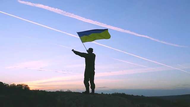 

Soldier Waves Ukrainian Flag Against Sunrise Sky. Slow Motion 

Soldier Waves Ukrainian Flag Against Sunrise Sky. Slow Motion 


