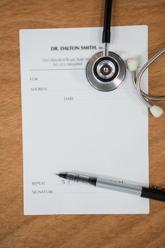 Close-up Of Doctor Letterhead With Stethoscope And Pen