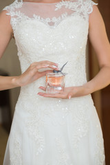 bride applying gentle perfume on her wrist