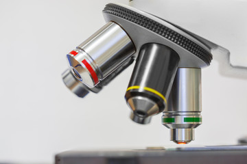 Medical microscope and three lenses with color labels