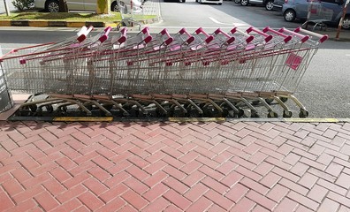 Empty line-up of shopping trolleys / carts in a row stacked outs