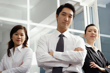 Executives standing with arms crossed