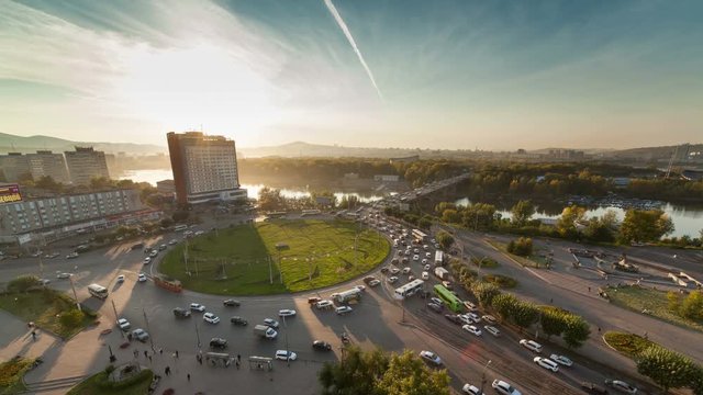 Autumn in the city sunset, traffic on the roundabout