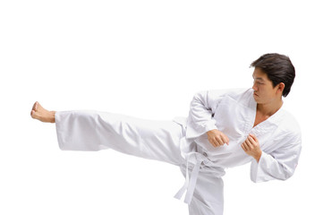 Young man in martial arts uniform, kicking