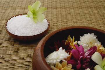 Fototapeta na wymiar Still life of flowers in bowl and a single flower head on bowl of rice