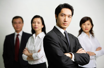Four business people looking at camera
