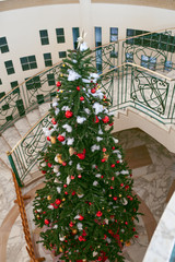 Decorated Christmas tree insade of the beautiful buildings