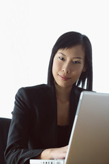 Businesswoman with laptop, looking at camera