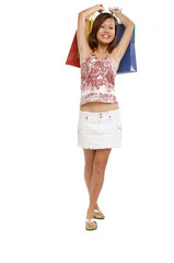 Young woman carrying shopping bags, smiling