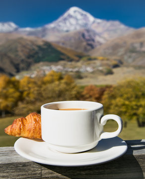Cup of coffee and Croissant  among beautiful nature of Georgia