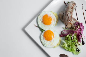 fried scrambled eggs with sausages;