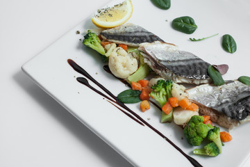steam cooked mackerel fish with vegetables isolated;