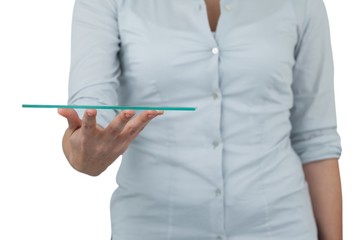 Mid section of businesswoman pretending to hold digital tablet