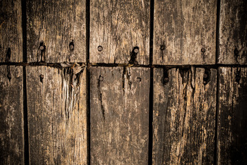 grunge texture of old rustic wood plate arranging in to bridge floor with nails.