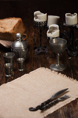 Burnt candle on the table. Against the backdrop of a still life of a medieval