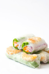 Vietnamese rolls with vegetables, rice noodles and prawns isolated on white background
