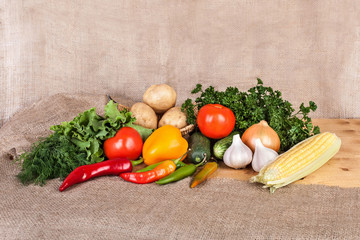 vegetables, grains and herbs on a wooden surface