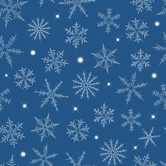 Fototapeta na wymiar Seamless pattern from snowflakes and stars on blue background.