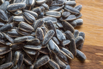 Grilled sunflower seeds with sea salt and spices on the wooden background