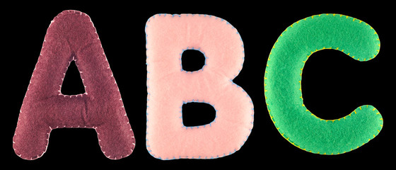 ABC- letters from colorful felt. Collection of colorful handmade English alphabet isolate on black...
