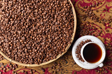 Cup of black coffee and  beans