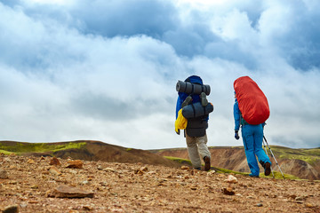 hikers on the trail in the Islandic mountains. Trek in National Park Landmannalaugar, Iceland
