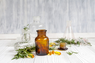 concept - natural medicine herbs in bottles on wooden background