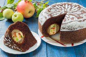 Chocolate cake with whole apples, curd and candied fruit