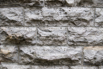 wet natural stone block wall