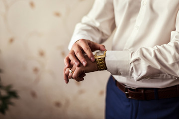 businessman clock clothes, businessman checking time on his wristwatch. men's hand with a watch, watch on a man's hand, the fees of the groom, wedding preparation, preparation for work, 