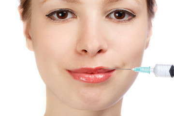 Lips plastic surgery injection on young woman face