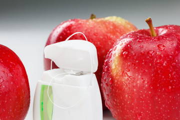 Dental teeth floss and red apple