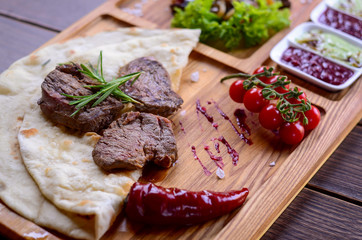 Tasty meat on a wooden background