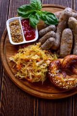 Tasty sausages with vegetables and sauce