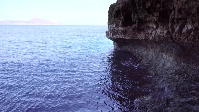 cave in montains on sea shore