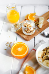 healthy breakfast bowl of yogurt with granola and banana