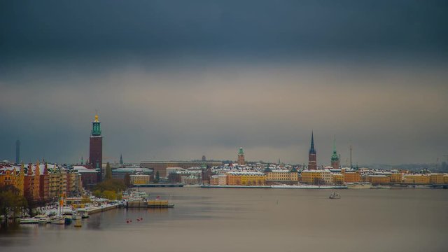 Time lapse of central Stockholm covered in snow with a public ferry crossing the bay.