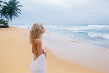 Fototapeta na wymiar Beautiful young woman on beach