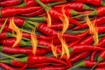 Spicy hot red thai peppers with flames bursting