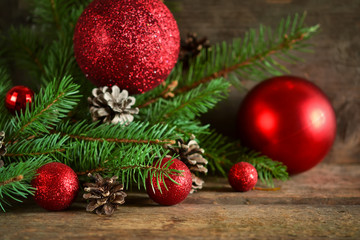 Obraz na płótnie Canvas Happy New Year - a holiday background with fir, balls, cones 