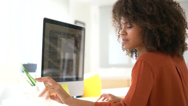 Cheerful businesswoman working on desktop computer