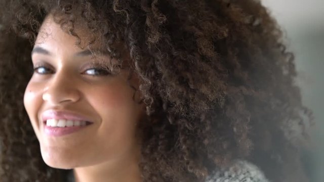 Attractive mixed-race woman smiling at camera