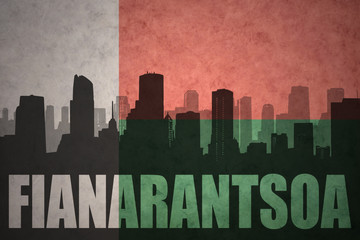 abstract silhouette of the city with text Fianarantsoa at the vintage madagascar flag