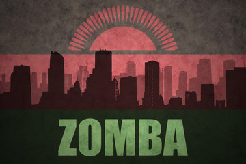 Fototapeta premium abstract silhouette of the city with text Zomba at the vintage malawi flag