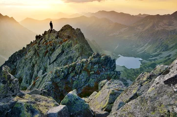 Papier Peint photo Lavable Colline Man on the top of the hill watching wonderful scenery in mountains during summer colorful sunset in High Tatras in Slovakia